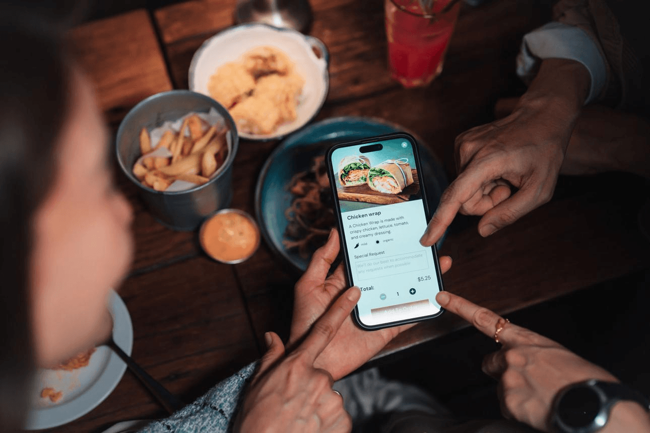 Guests using a digital restaurant menu together at the table
